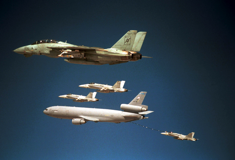 F-14A inflight to attack Afghanistan carries a Aim-54 Phoenix missile on its wing root pylon, this is quite rare as the F-14 couldn’t land with its intended six safely on a carrier. Typically carried in the “Pancake” between the engines in this case that area is holding 2,000 pound bombs to strike the Talibans strongholds. The F-14A cannot land with all these weapons but there extremely unlikely not to launch the JDAMs as at this point their are still plenty of targets to strike. KC-10 Extender and Hornets in the background, October 7th, 2001. The first attack.